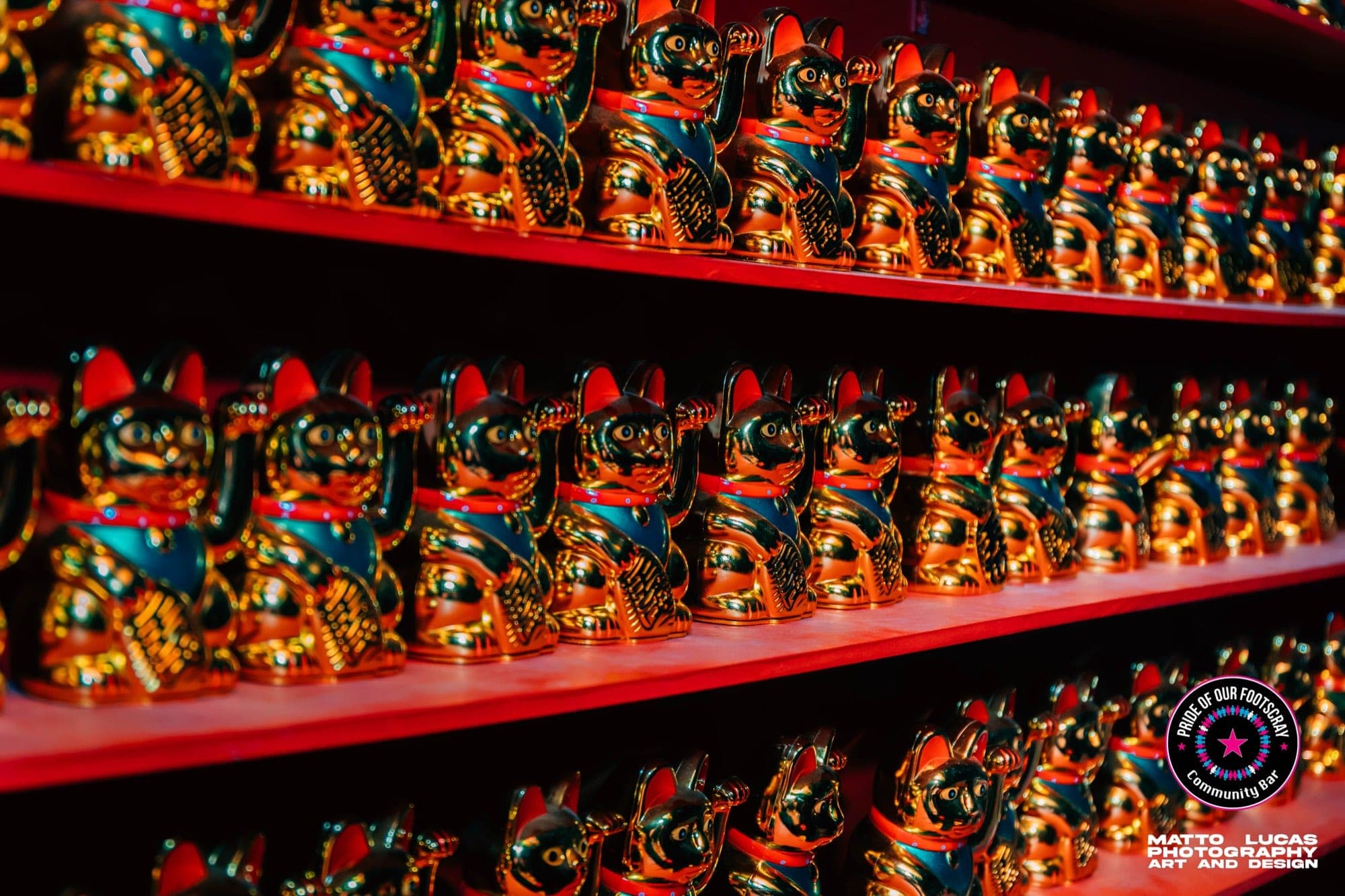 Painted wall of waving lucky cats inside Pride of our Footscray